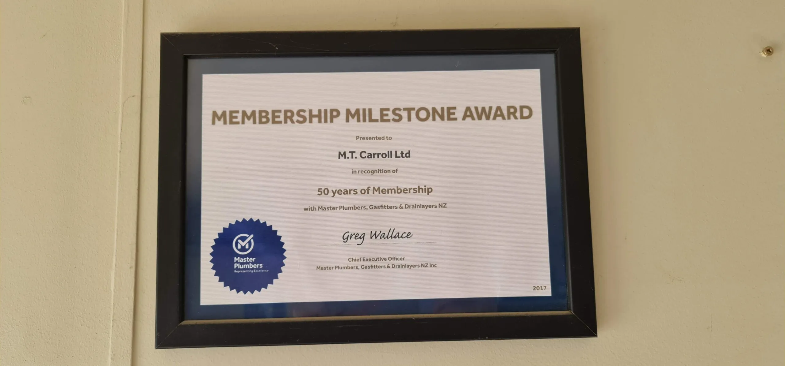 A framed Membership Milestone Award presented to M.T. Carroll Ltd for 50 years of membership with Master Plumbers, Gasfitters and Drainlayers NZ