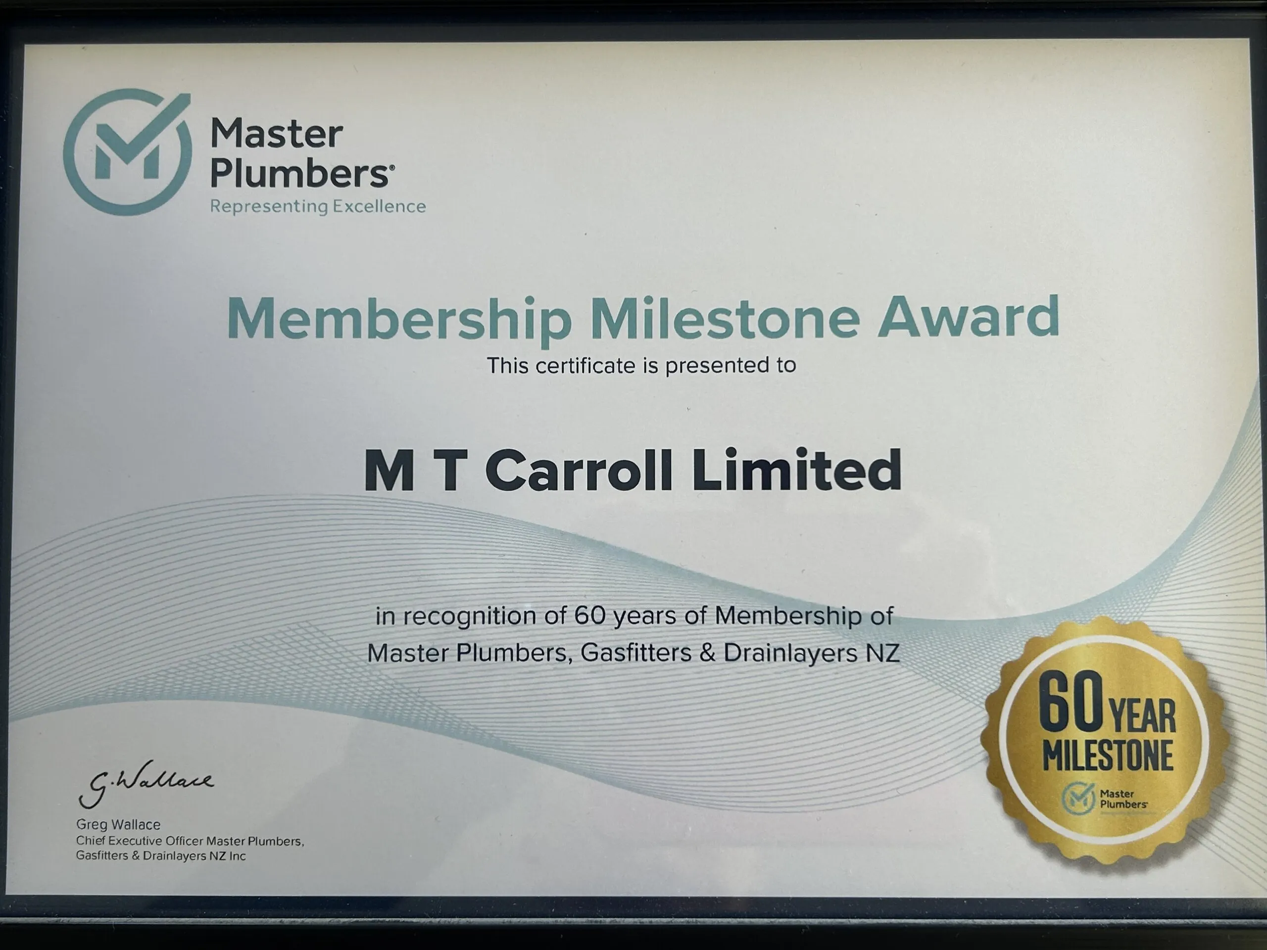 A framed Membership Milestone Award presented to M T Carroll Limited in recognition of 60 years of membership of Master Plumbers, Gasfitters and Drainlayers NZ