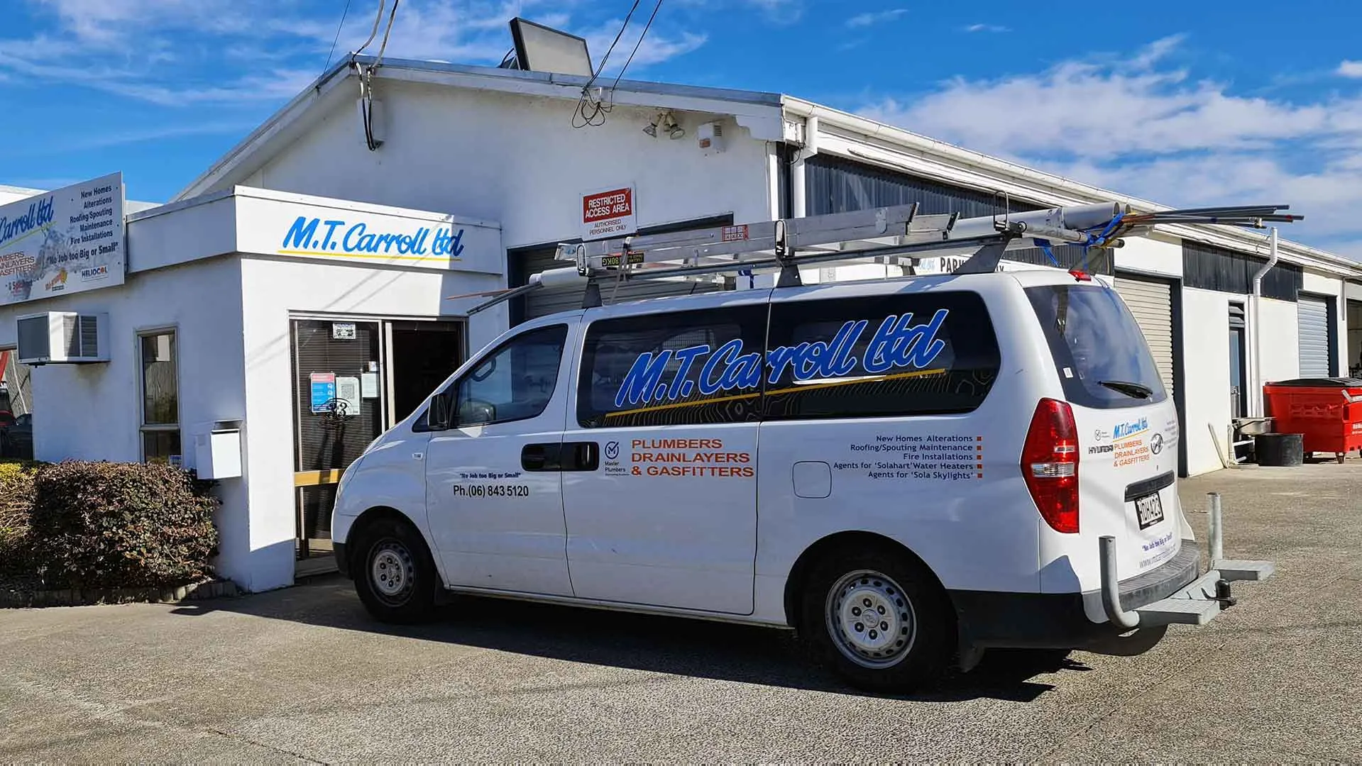 An M.T. Carroll Limited van signwritten Plumbers, Drainlayers and Gasfitters, parked at the workshop on Cadbury Road in Napier